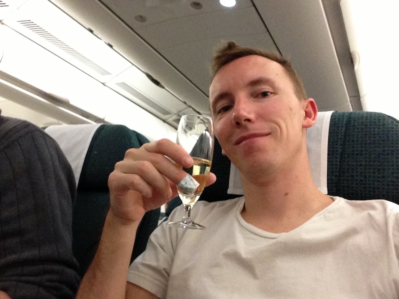 Carl drinking bubbly on Cathay Pacific